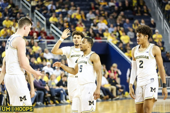 Jon Teske (15), Isaiah Livers (4), Jaaron Simmons (5), and Jordan Poole (2)