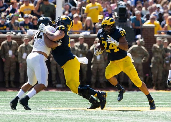 Jalen Mayfield (73) and Zach Charbonnet (24)