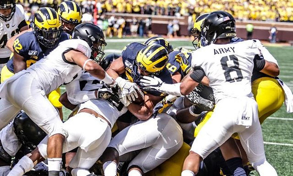 Nick Eubanks (82), Zach Charbonnet (24), and Ryan Hayes (76)