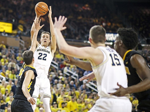 Duncan Robinson (22) and Jon Teske (15)