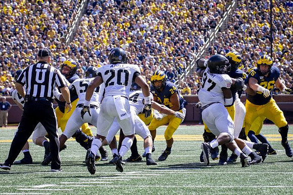 Zach Charbonnet (24), Cesar Ruiz (51), and Ryan Hayes (76)