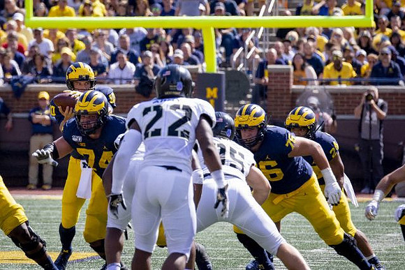 Dylan McCaffrey (10), Ben Bredeson (74), Ryan Hayes (76), and Zach Charbonnet (24)