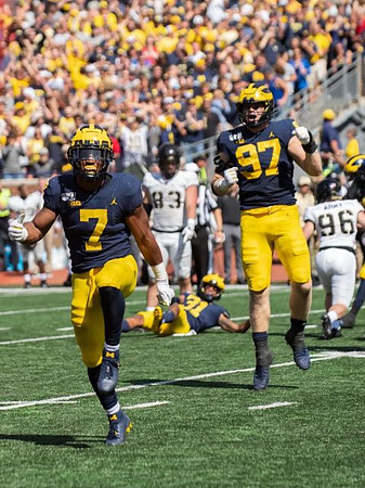 Khaleke Hudson (7), Aidan Hutchinson (97), and Vincent Gray (31)