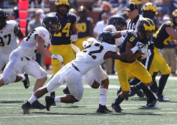 Zach Charbonnet (24), Ronnie Bell (8), and Sean McKeon (84)