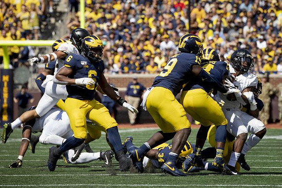 Josh Uche (6), Kwity Paye (19), and Josh Metellus (14)