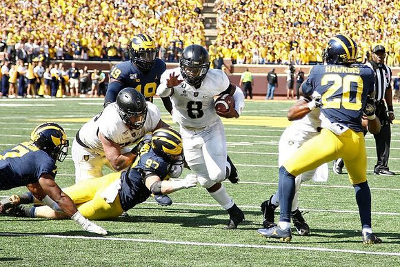 Khaleke Hudson (7), Aidan Hutchinson (97), Kwity Paye (19), and Brad Hawkins (20)