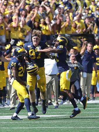 Lavert Hill (24), Aidan Hutchinson (97), and Vincent Gray (31)