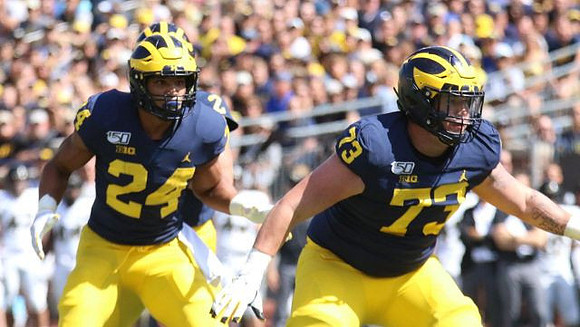 Zach Charbonnet (24) and Jalen Mayfield (73)