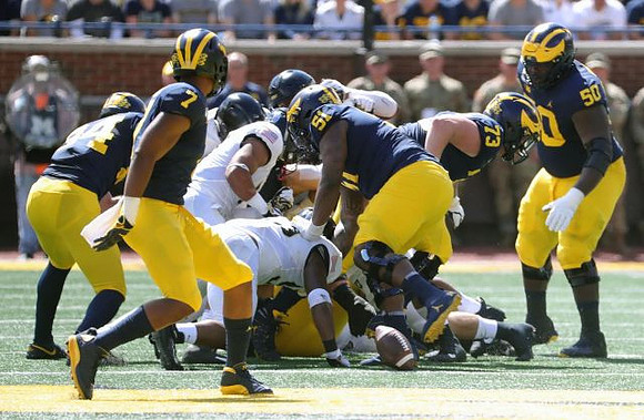 Sean McKeon (84), Tarik Black (7), Cesar Ruiz (51), Jalen Mayfield (73), and Michael Onwenu (50)