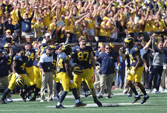 Lavert Hill (24), Aidan Hutchinson (97), and Vincent Gray (31)
