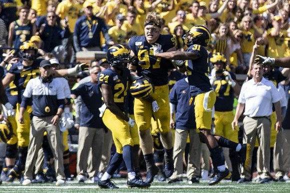Lavert Hill (24), Aidan Hutchinson (97), and Vincent Gray (31)