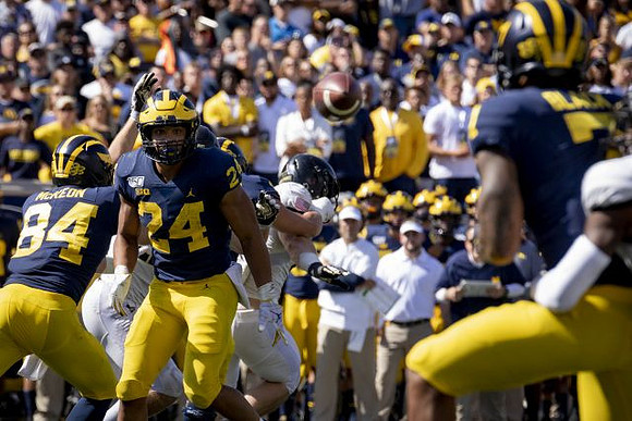 Sean McKeon (84), Zach Charbonnet (24), and Tarik Black (7)