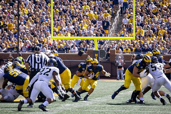 Cesar Ruiz (51), Dylan McCaffrey (10), Zach Charbonnet (24), and Ryan Hayes (76)