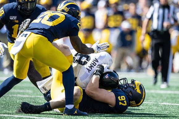 Kwity Paye (19), Brad Hawkins (20), and Aidan Hutchinson (97)