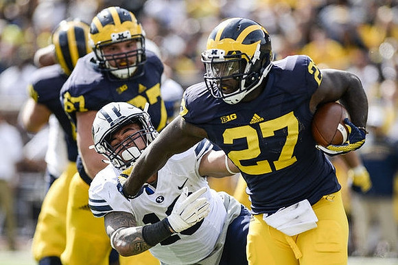 Kyle Kalis (67) and Derrick Green (27)