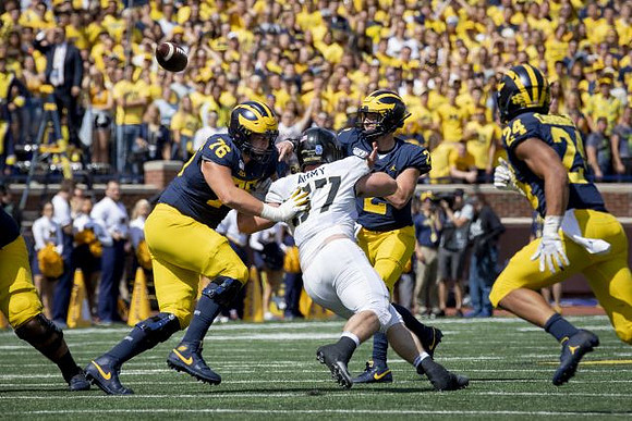 Ryan Hayes (76), Shea Patterson (2), and Zach Charbonnet (24)