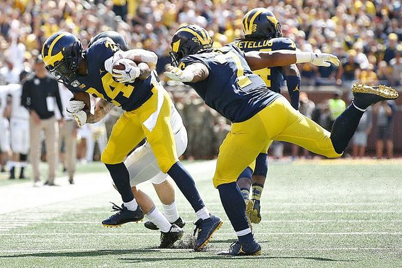 Lavert Hill (24), Khaleke Hudson (7), and Josh Metellus (14)