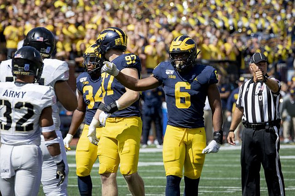 Jordan Anthony (34), Aidan Hutchinson (97), and Josh Uche (6)