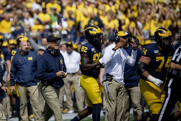 Jim Harbaugh, Nick Eubanks (82), and Ben Bredeson (74)