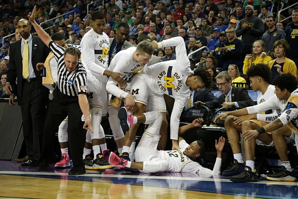 Muhammad-Ali Abdur-Rahkman (12) and Michigan Team