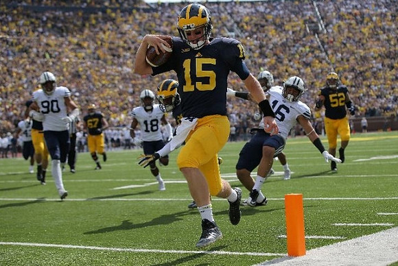 Jake Rudock (15), Kyle Kalis (67), and Mason Cole (52)