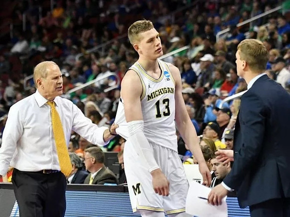 John Beilein, Moritz Wagner (13), and Luke Yaklich