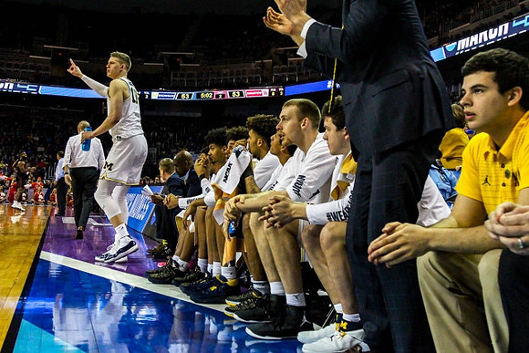 Moritz Wagner (13) and Michigan Team
