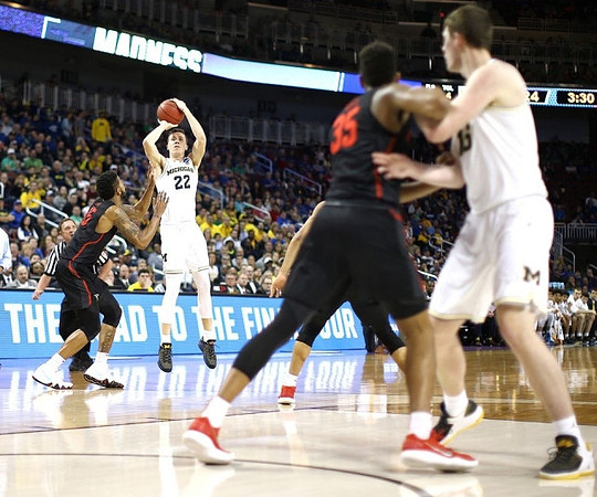 Duncan Robinson (22) and Jon Teske (15)