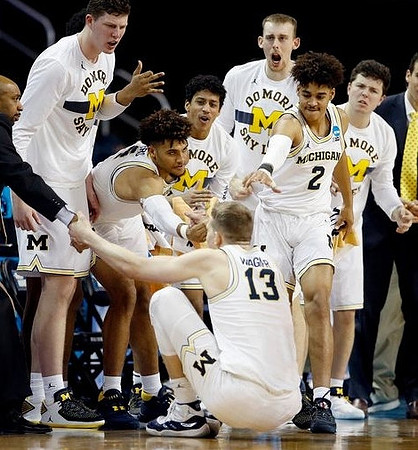 Moritz Wagner (13) and Michigan Team