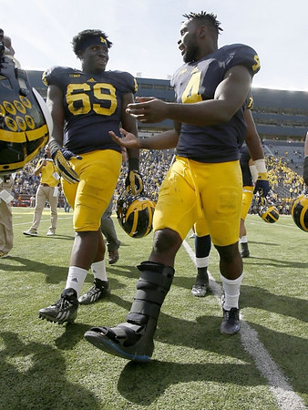 Willie Henry (69) and De'Veon Smith (4)