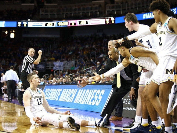 Moritz Wagner (13) and Michigan Team