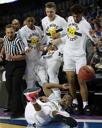 Muhammad-Ali Abdur-Rahkman (12) and Michigan Team