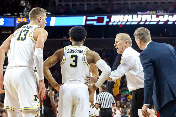 Moritz Wagner (13), Zavier Simpson (3), John Beilein, and Luke Yaklich
