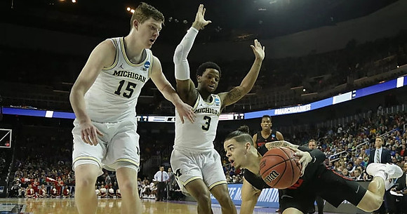 Jon Teske (15) and Zavier Simpson (3)