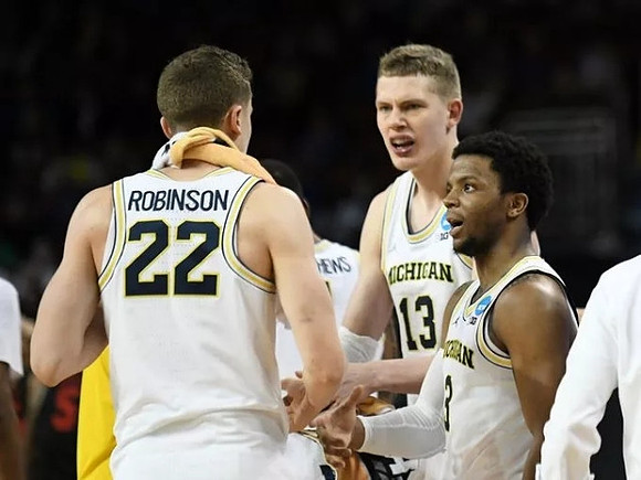 Duncan Robinson (22), Moritz Wagner (13), and Zavier Simpson (3)