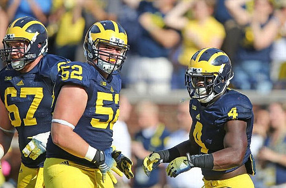 Kyle Kalis (67), Mason Cole (52), and De'Veon Smith (4)