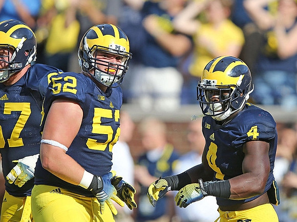 Kyle Kalis (67), Mason Cole (52), and De'Veon Smith (4)