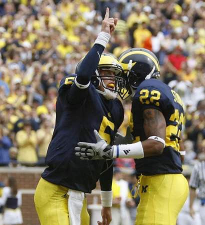 Tate Forcier (5) and Darryl Stonum (22)