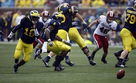 Denard Robinson (16), Brandon Minor (4), David Moosman (60), and Perry Dorrestein (79)