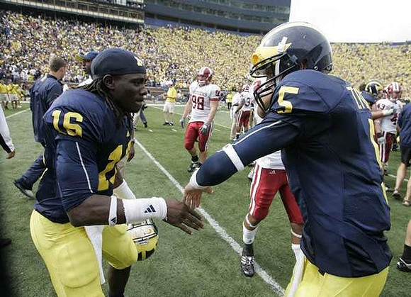 Denard Robinson (16) and Tate Forcier (5)