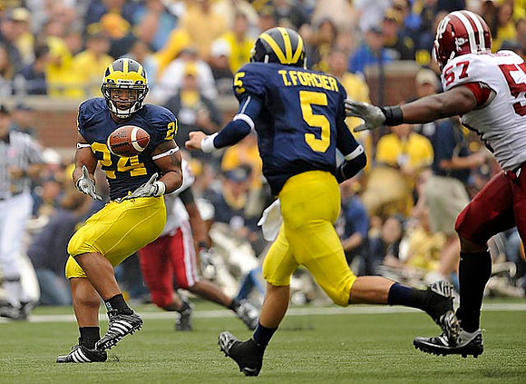 Kevin Grady (24) and Tate Forcier (5)