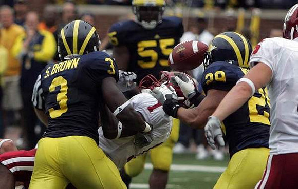 Stevie Brown (3), Brandon Graham (55), and Troy Woolfolk (29)