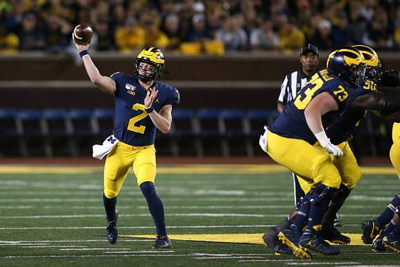 Shea Patterson (2), Jalen Mayfield (73), and Michael Onwenu (50)