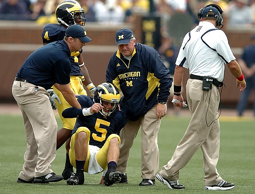 Brandon Minor (4), Tate Forcier (5), and Rich Rodriguez
