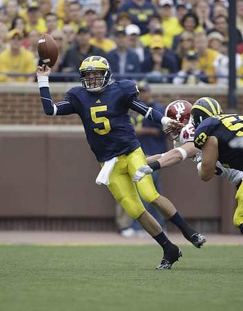 Tate Forcier (5) and Stephen Schilling (52)