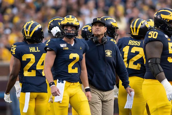 Lavert Hill (24), Shea Patterson (2), Jim Harbaugh, Josh Ross (12), and Michael Onwenu (50)