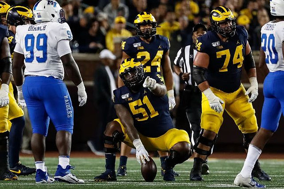 Cesar Ruiz (51), Zach Charbonnet (24), and Ben Bredeson (74)