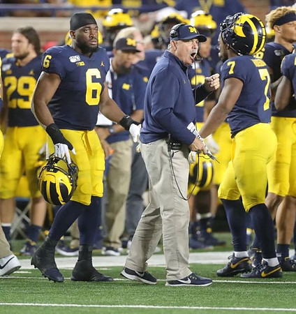 Jordan Glasgow (29), Josh Uche (6), Don Brown, and Khaleke Hudson (7)