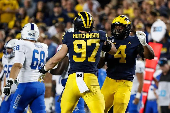 Aidan Hutchinson (97) and Michael Danna (4)