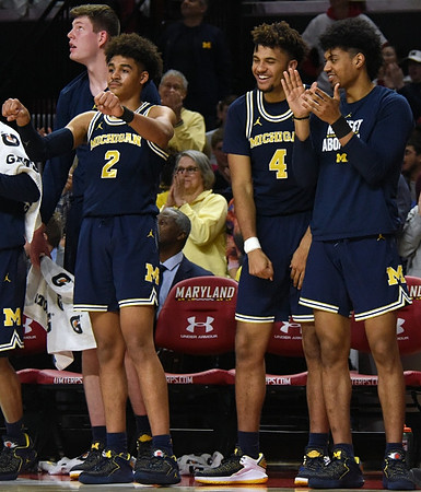 Jon Teske (15), Jordan Poole (2), Isaiah Livers (4), and Ibi Watson (23)